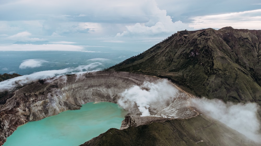 a rocky cliff with a body of water below