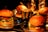 Four hamburgers are placed on metal trays, each containing lettuce, tomatoes, and sauce. A small bucket filled with french fries is also visible in the center, surrounded by the hamburgers. The setting appears to be dimly lit with a warm, inviting glow.