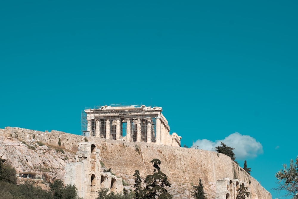 a large stone building on a hill