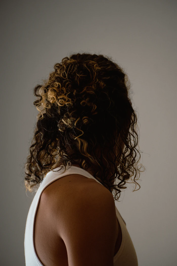 Defined dark curls, seen from behind