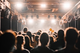 a crowd of people in a room with a stage and a stage