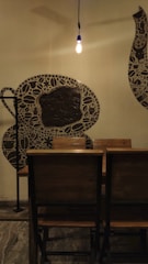 Cozy coffee shop interior with warm lighting and artistic photo shoot setup.