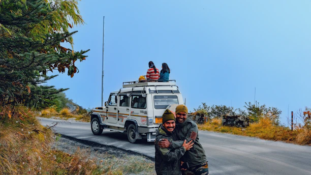 A happy family stepping into a comfortable car with Nepal’s mountains in the background.