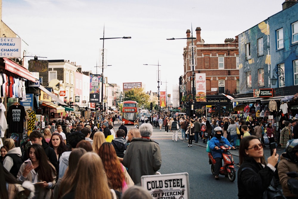 a crowd of people walking down a street