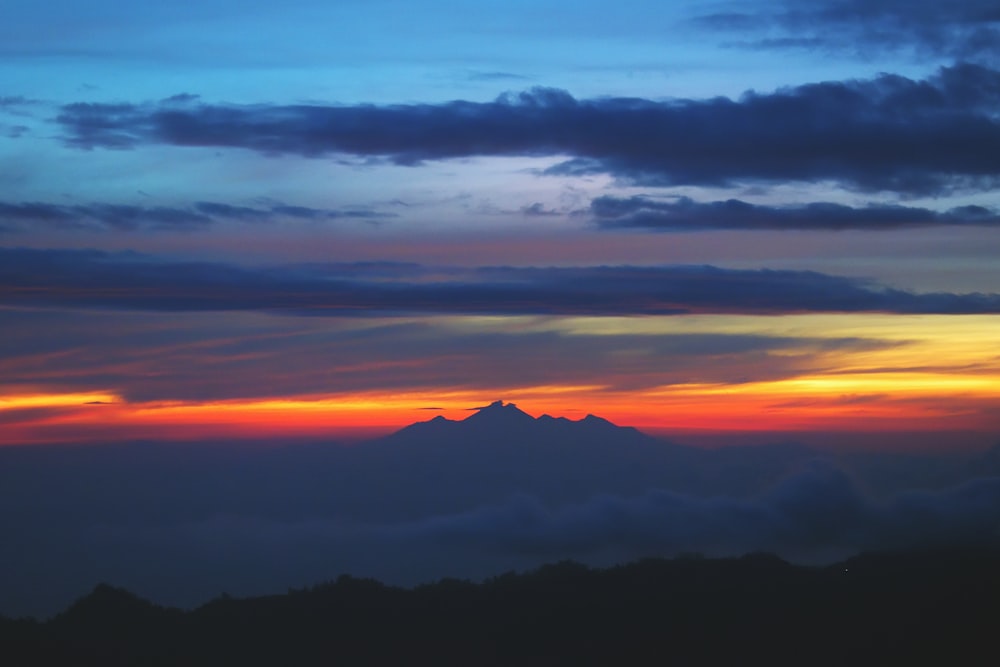 a sunset over a mountain range