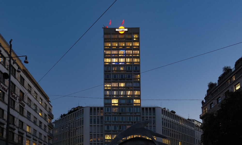 a tall building with lights on at night