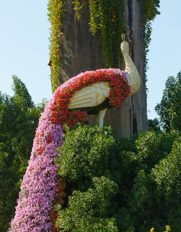 Lifelike garden decor sculpture of a peacock blending art with nature.