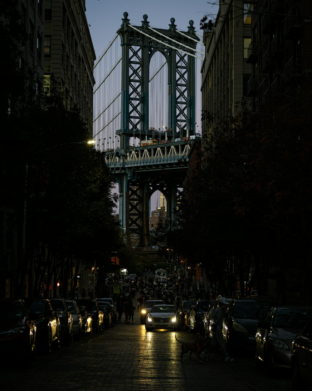 a street with cars and a bridge