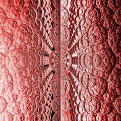 A complex fractal pattern featuring an array of intricately textured circular shapes, creating a symmetrical design. The pattern creates a sense of depth and perspective, with the circles appearing to extend infinitely inward.