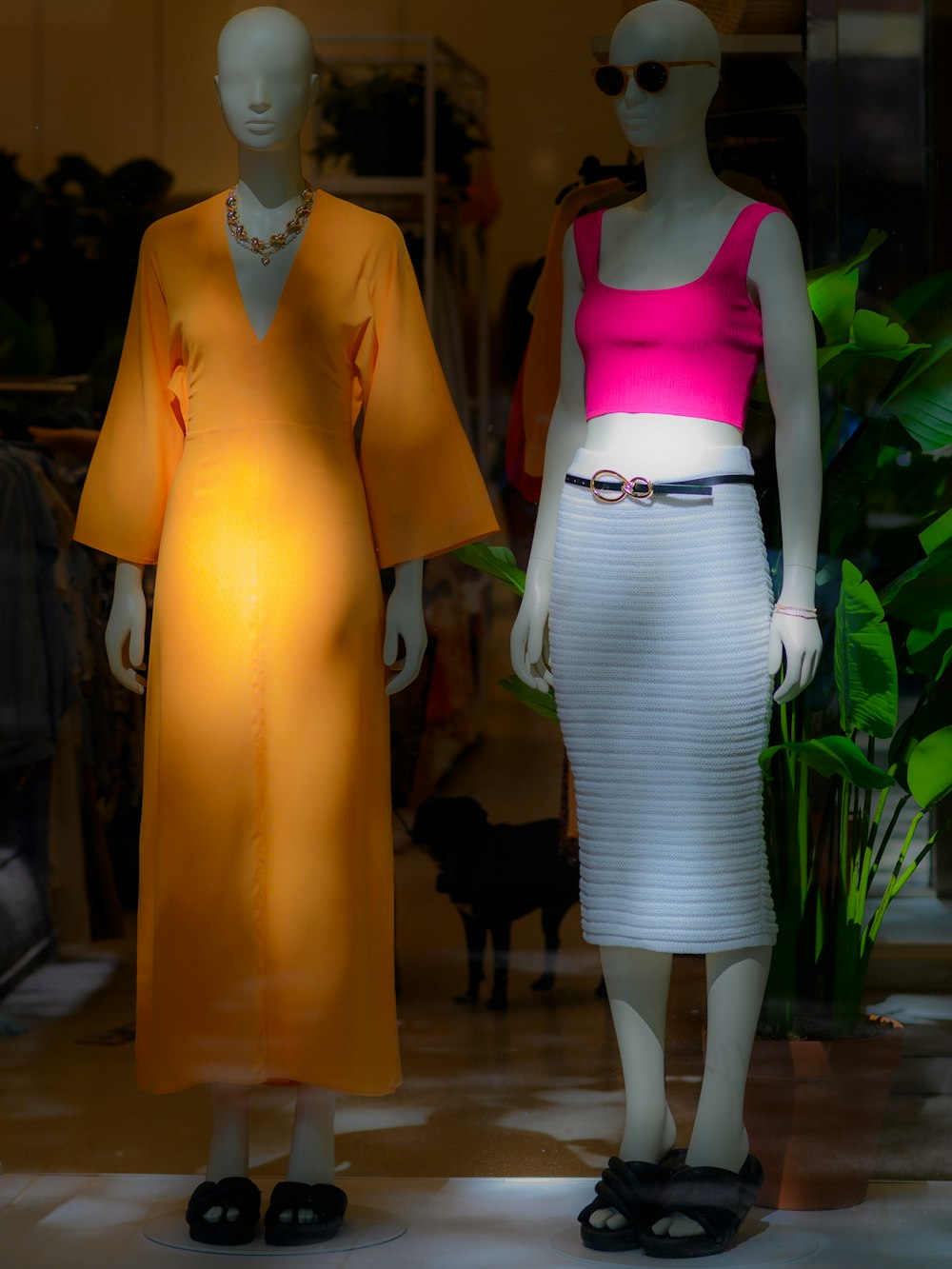 a couple of mannequins wearing clothing