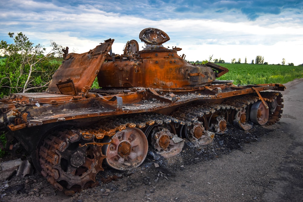 a rusted out tank on a road