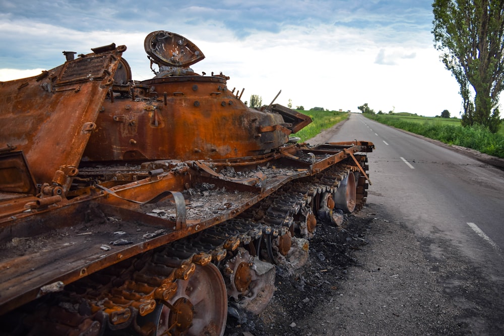 a rusted out truck on a road