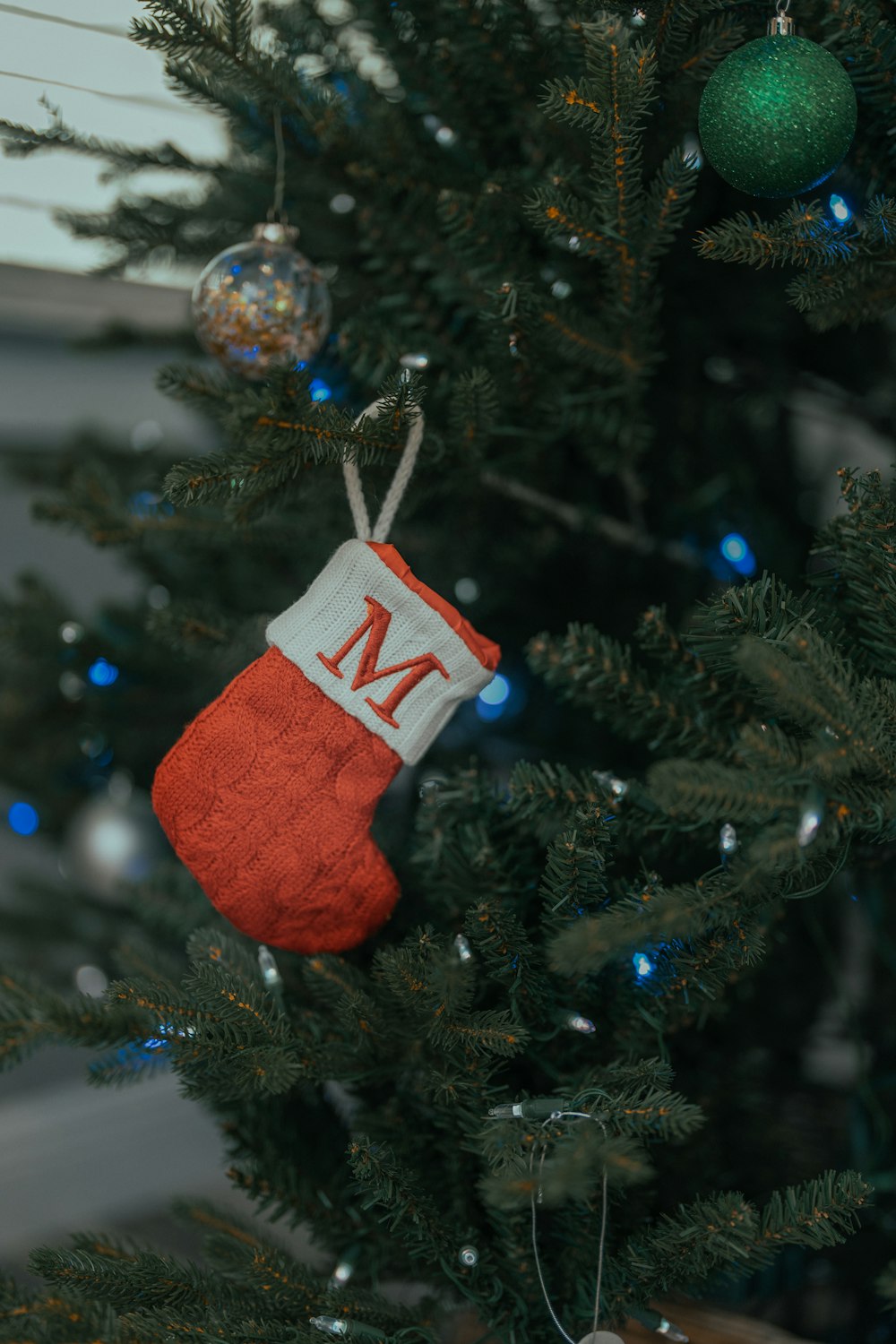 a christmas tree with a red and white box from it