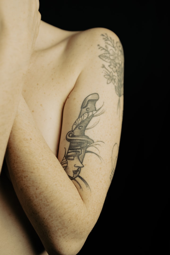 A linework tattoo on a person's arm, standing in for the mountain-peak silhouette of flash design №009