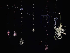 A cheerful, colorful mobile bar setup with string lights glowing warmly at dusk.