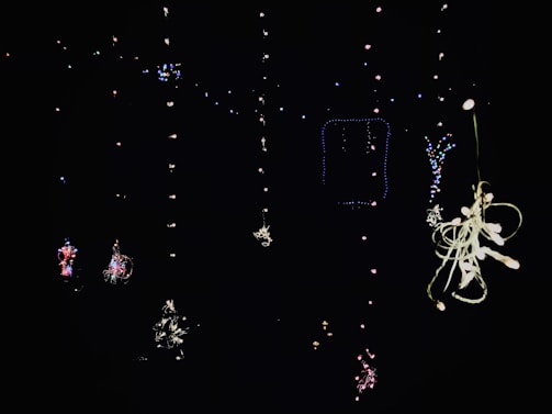 A cheerful, colorful mobile bar setup with string lights glowing warmly at dusk.