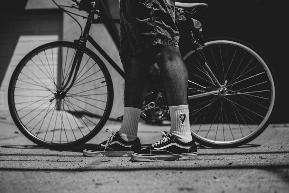 a person standing next to a bicycle