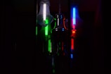 3D-rendered floating milk bottles glowing softly with neon green highlights against a dark charcoal background.