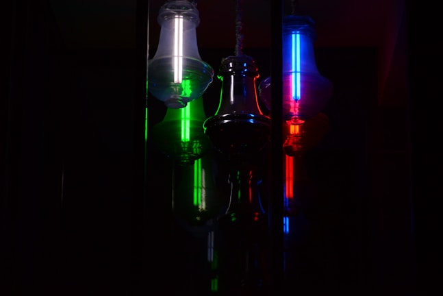 3D-rendered floating milk bottles glowing softly with neon green highlights against a dark charcoal background.