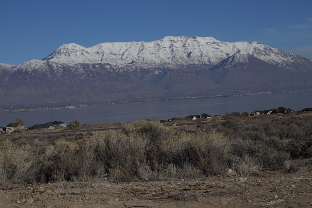 a snowy mountain with a lake below