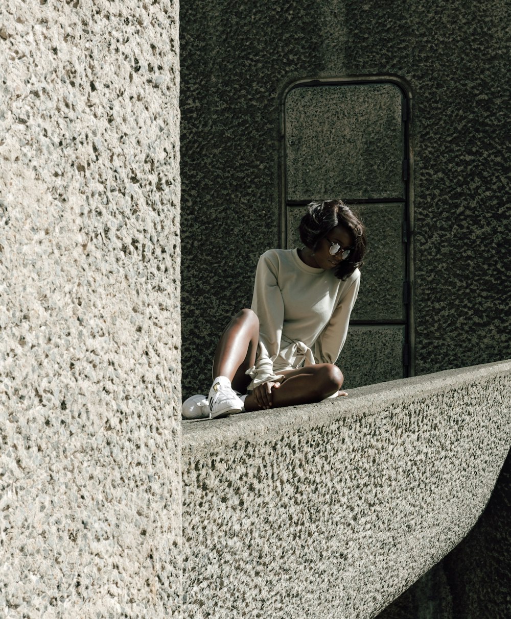 a person sitting on a ledge