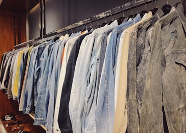 A row of colorful jackets hanging on a minimalist clothing rack.