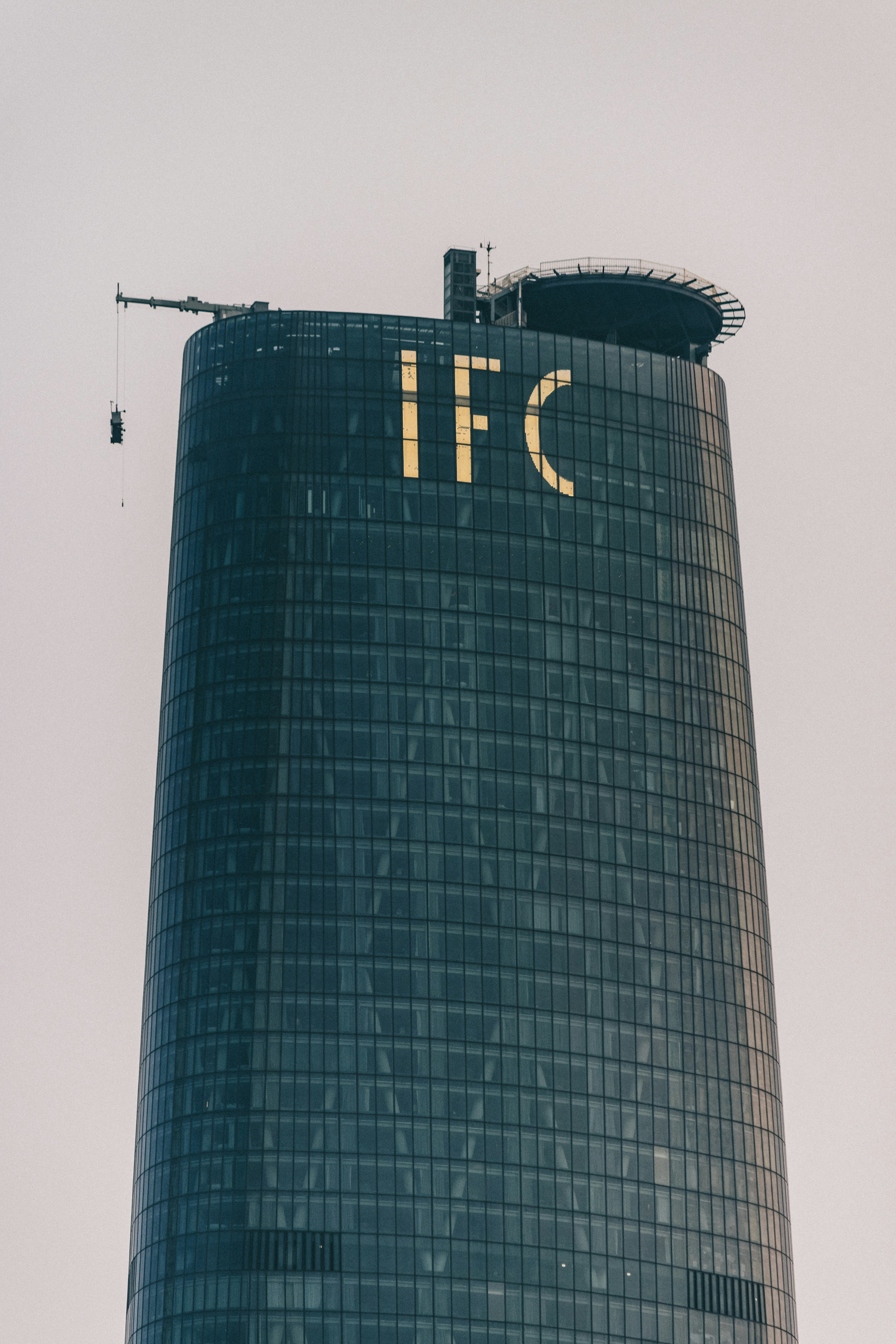 A tall building with a person standing on top photo – Free China Image ...