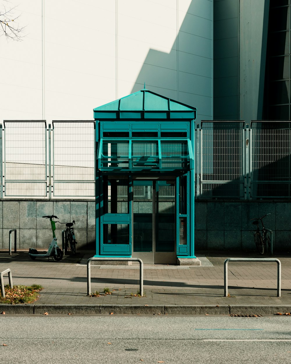 a blue building with a metal fence