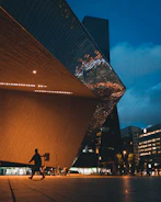 Modern architectural blueprint overlaying a sleek city skyline at dusk