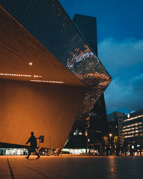 Modern architectural blueprint overlaying a sleek city skyline at dusk