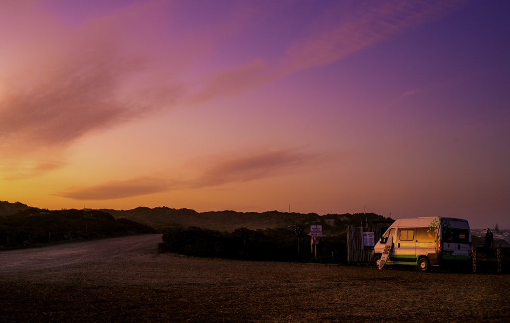 a van parked on a dirt road