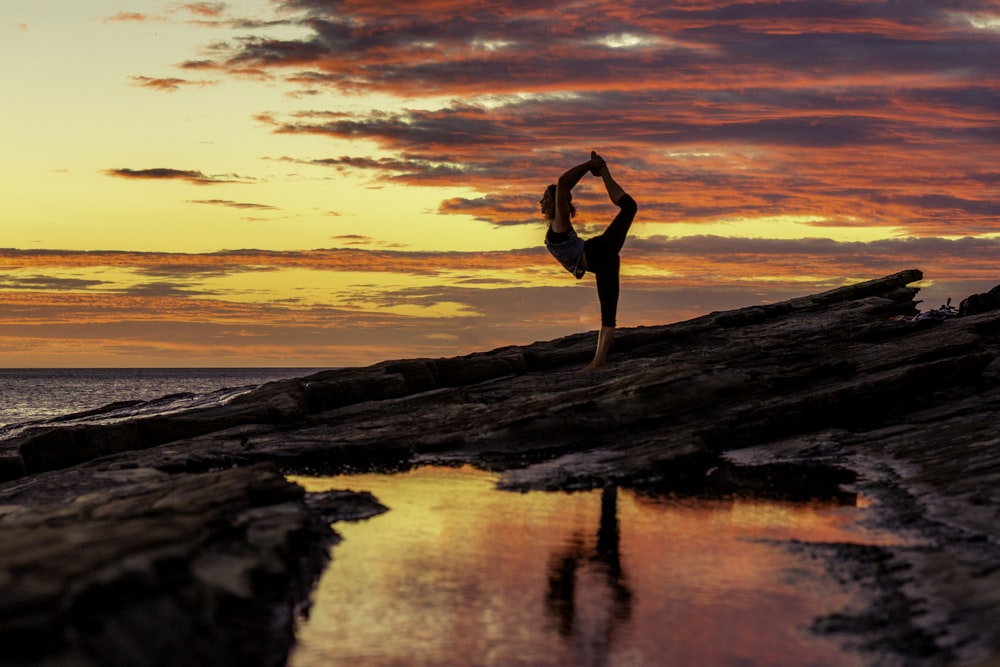 a person doing a handstand on a beach