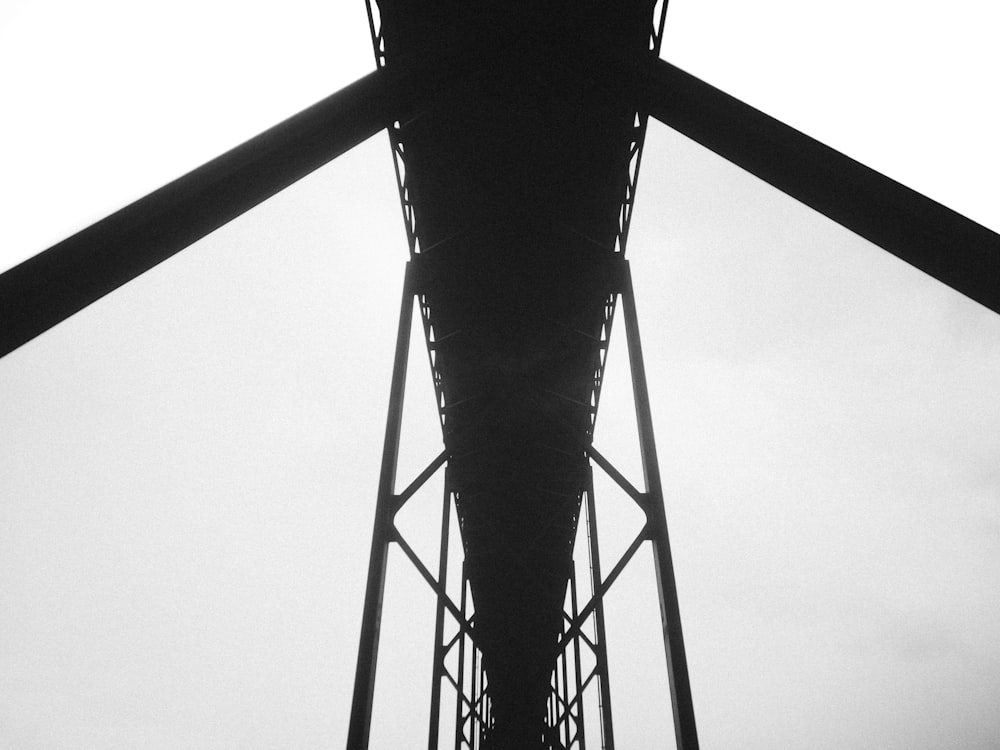 a black and white photo of a power line tower