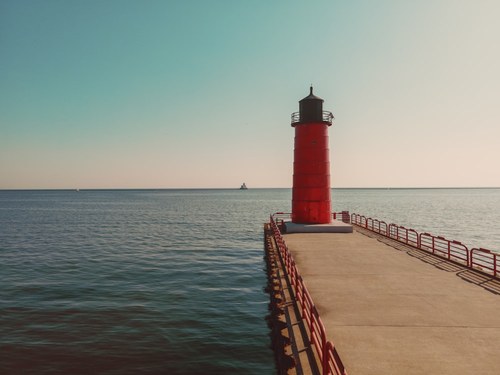 a red light house on a pier