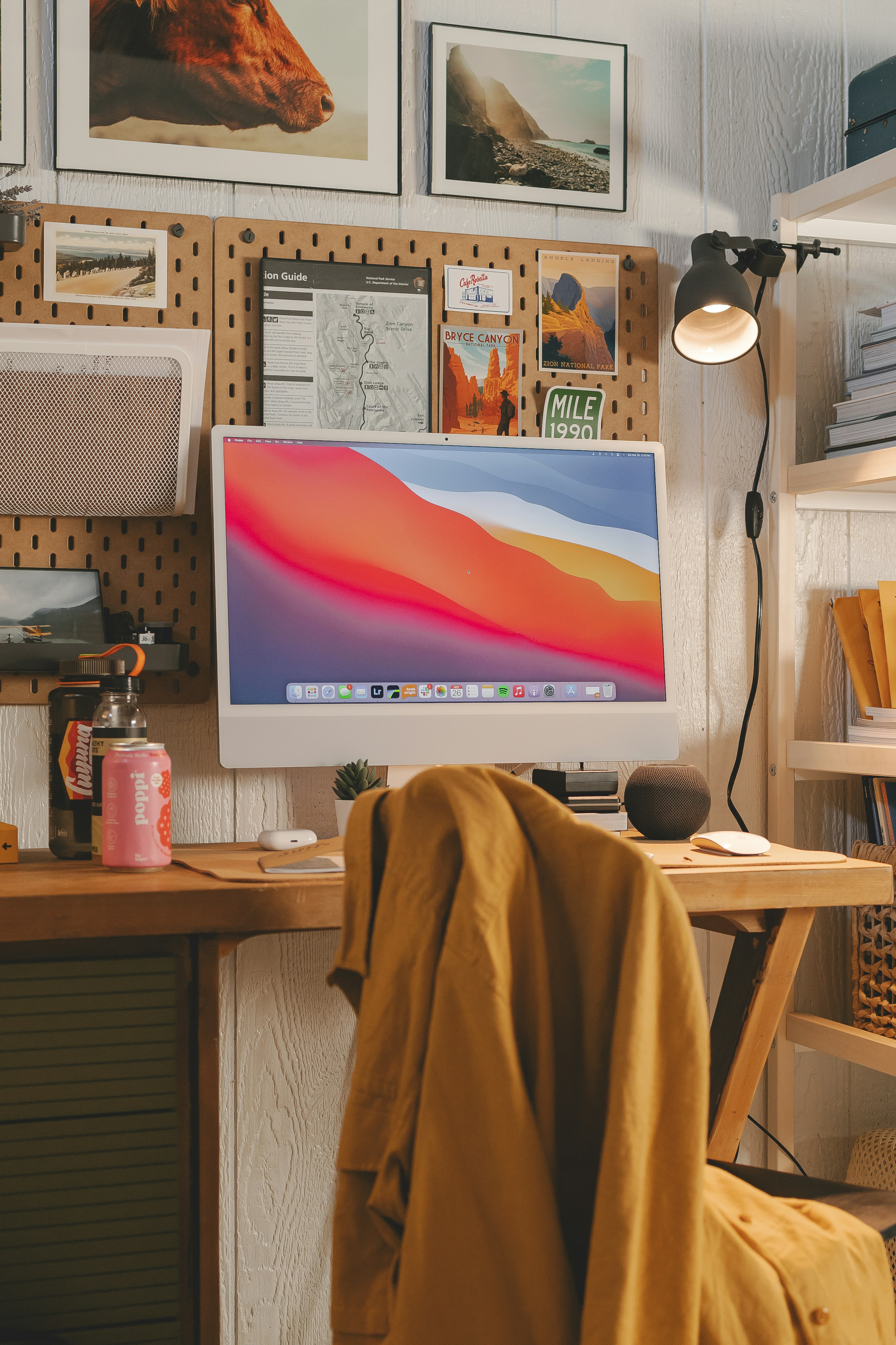 a desk with a computer and a lamp on it
