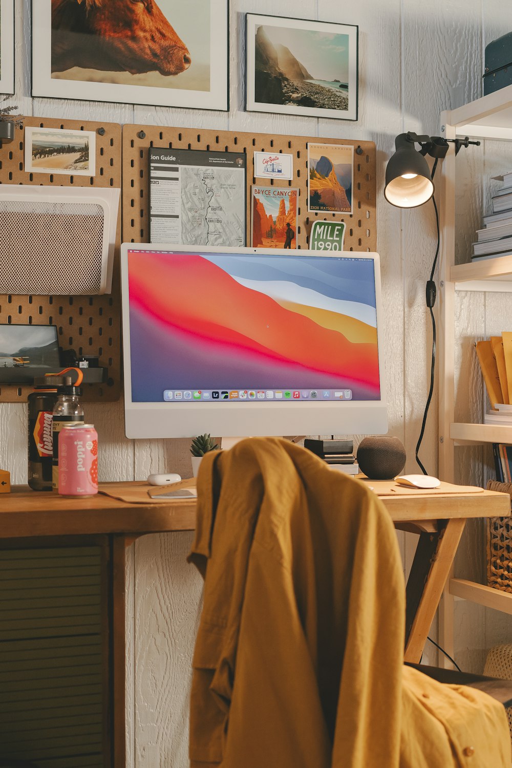 a desk with a computer and a lamp on it