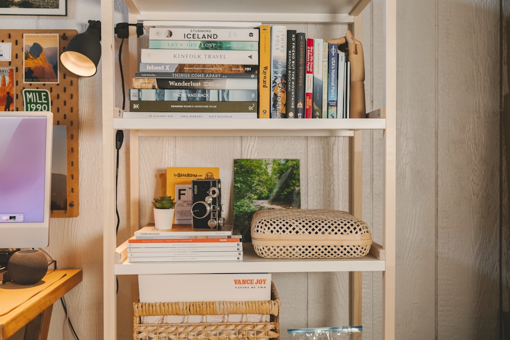 a bookshelf with books and a basket on it