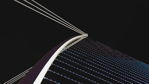 A dynamic bridge network symbolizing connection and speed under a clear sky