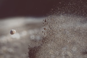 Close-up of controlled rock blasting with dust and debris flying.