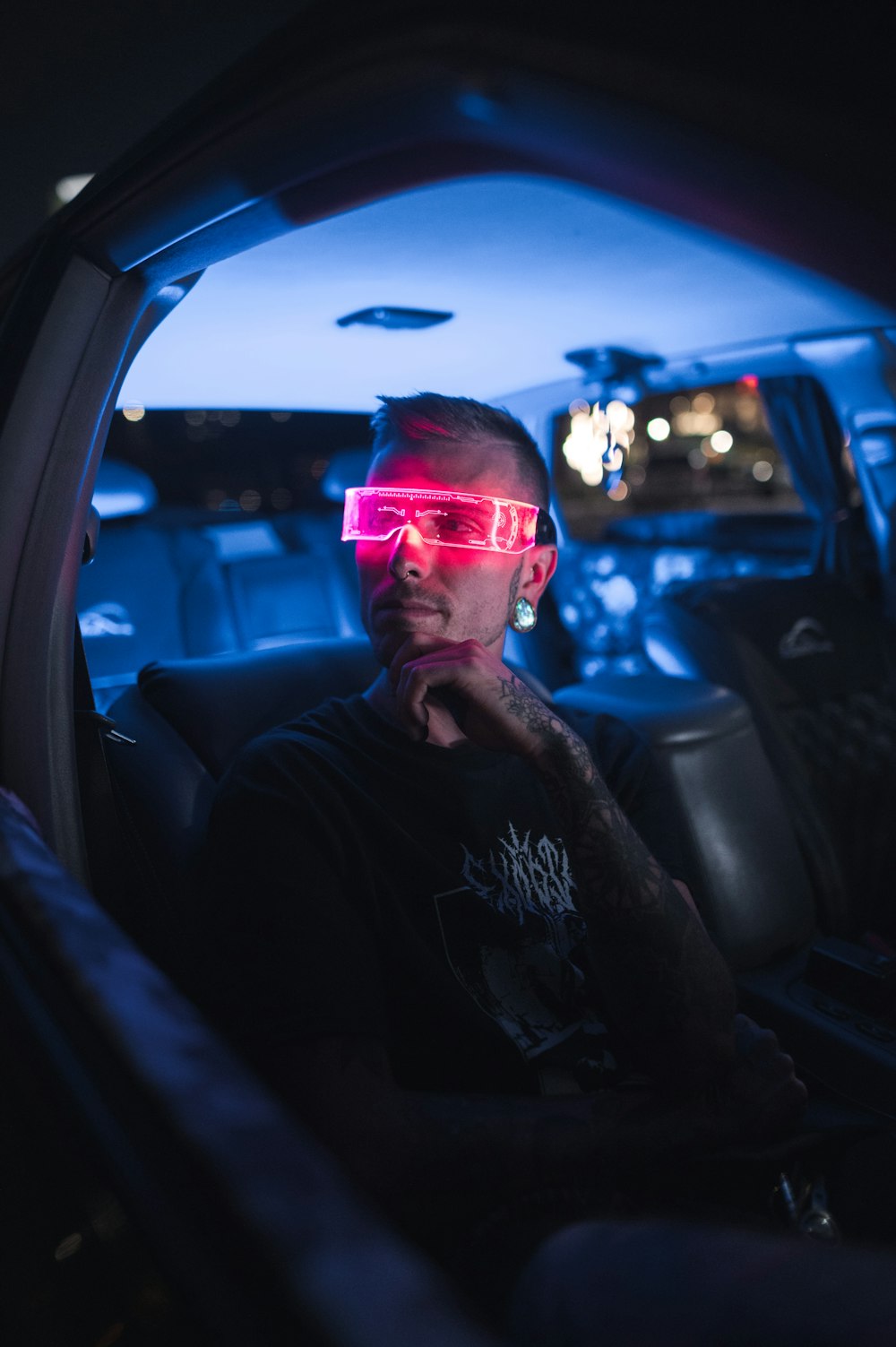 a man wearing sunglasses and sitting in a car