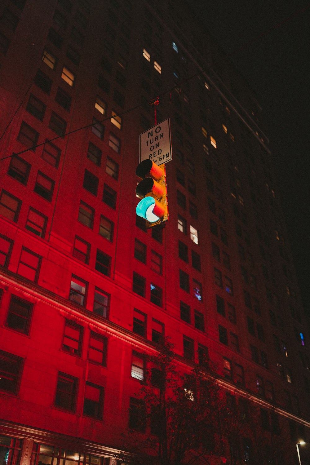 a stop light in front of a tall building