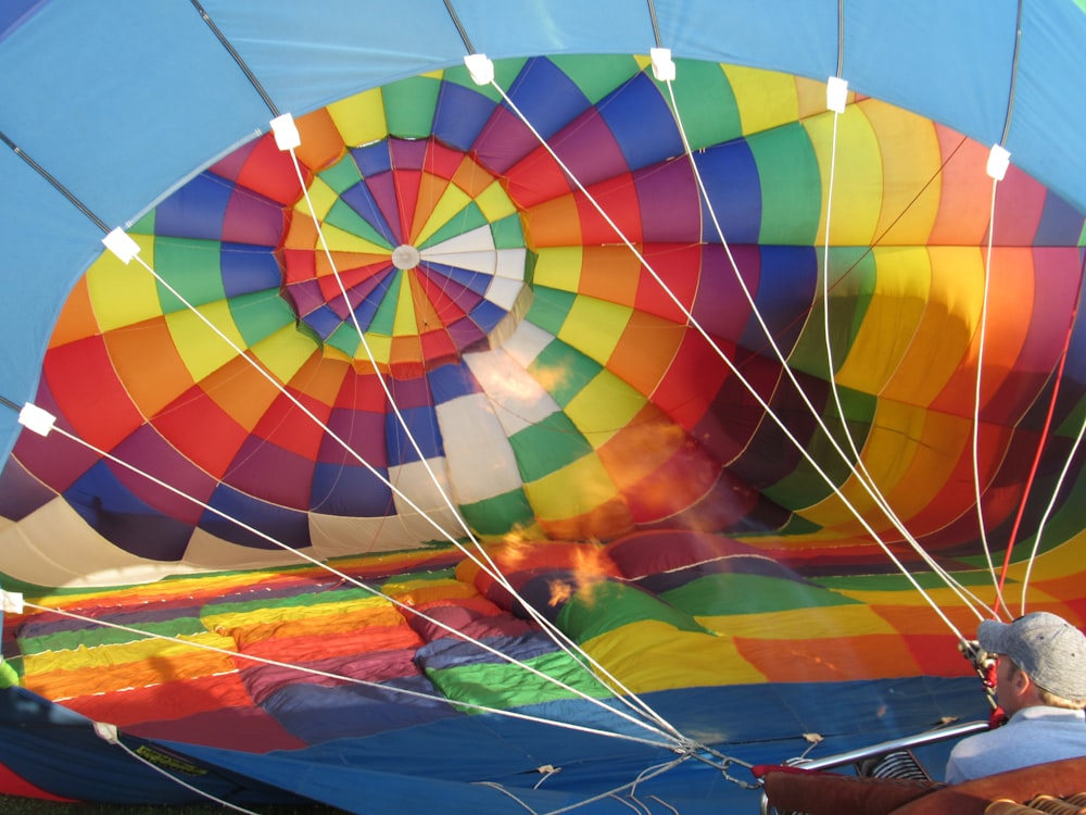 a person looking at a colorful hot air balloon