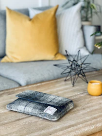 A cozy living room scene featuring a klevas wooden tissue box on a rustic coffee table.