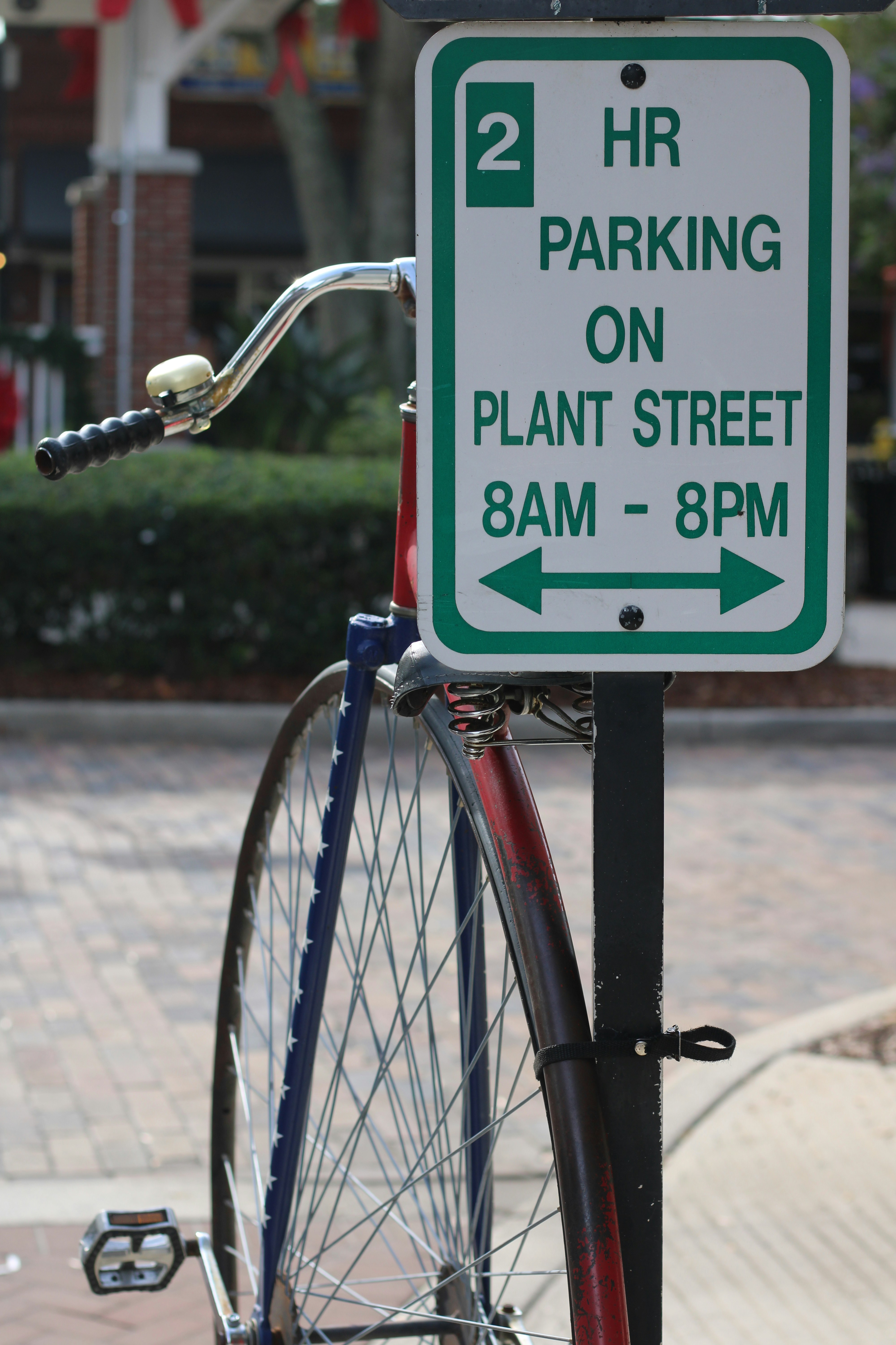 a bicycle is parked next to a sign