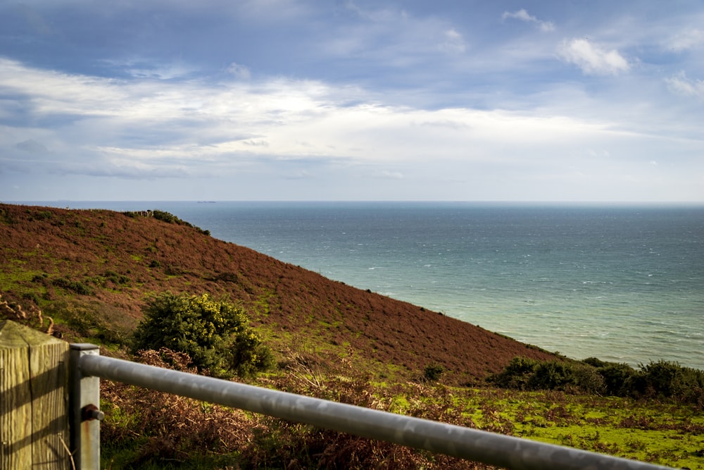 a railing overlooking a body of water with Thornton State Beach in the background