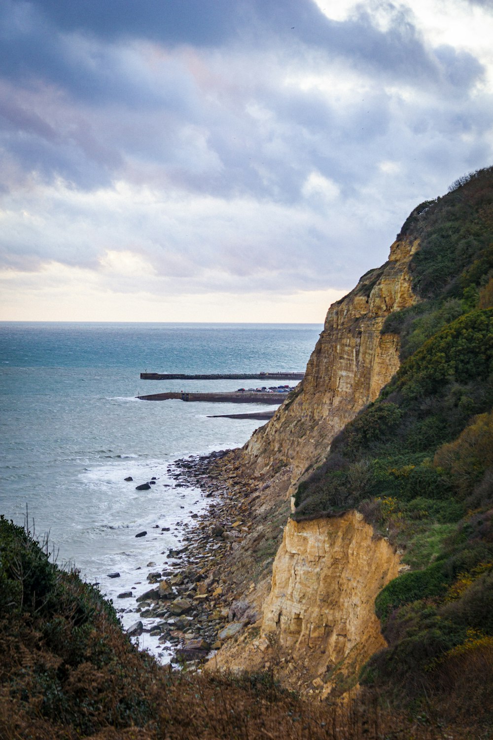 a rocky cliff overlooking a body of water