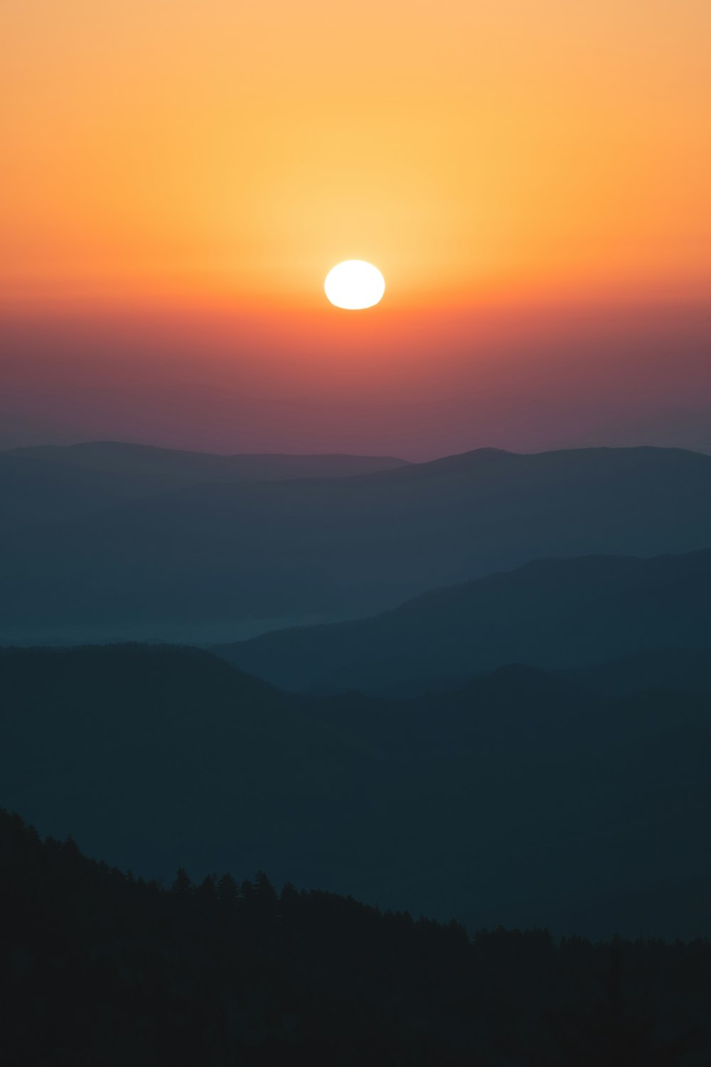 a sunset over a mountain range