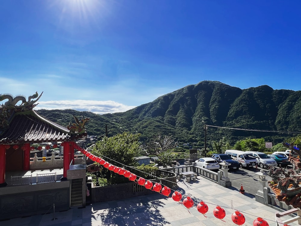 a parking lot with cars and mountains in the background