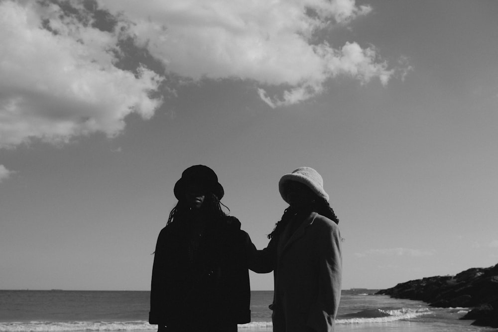 a couple of people looking at the ocean