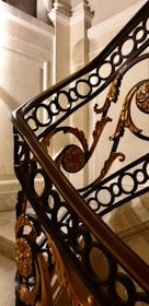 A close-up of intricate metalwork on a staircase railing.